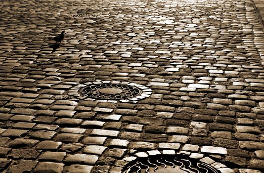 ancient road with paved stone blocks at night