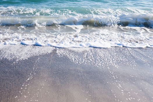 Soft wave of Black sea on sandy beach. Nature Background