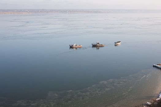 A few small ships in the winter sea near coast