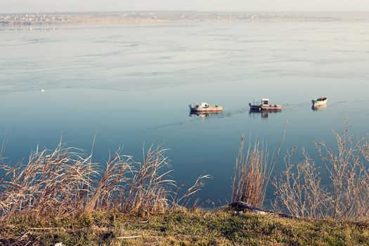 A few small ships in the winter sea near coast