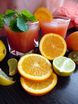 Fresh juice with fruits on wooden table