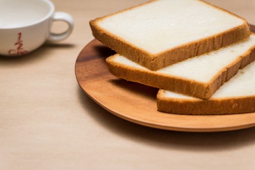 Close-up of slice of toast bread on wood table