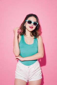 Summer lady. Beautiful asian girl with professional makeup and stylish hairstyle on pink background.