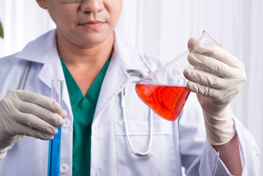 Male scientist holds and examine samples