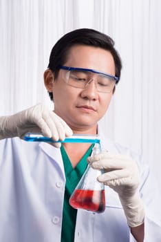 Male scientist holds and examine samples