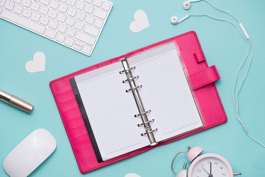 Mother's Day concept. Pink roses with gift box on woman office desk. Open notebook for copy space.