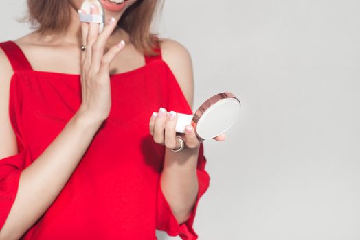 Fashion lifestyle portrait of young asian woman holding foundation cosmetic product 