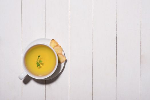 Healthy ginger tea ingredients on a wooden table