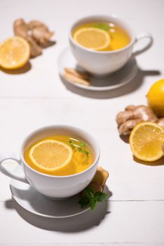 Healthy ginger tea ingredients on a wooden table