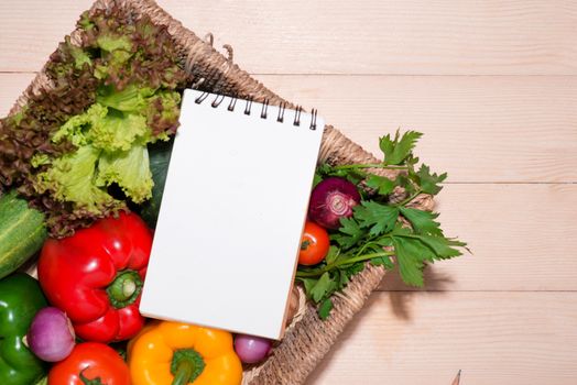 Open recipe book with organic vegetarian ingredients.