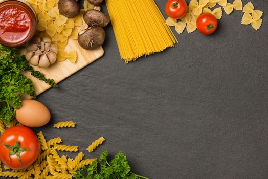 Italian spaghetti photo recipe with copy space on the kitchen table surrounded with products.