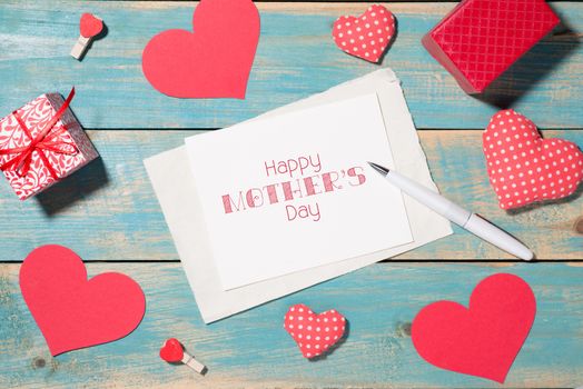 Valentine's Day greeting card over wooden background. Top view with copy space