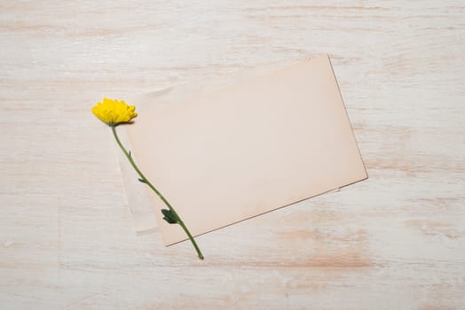 Yellow daisy bouquet on wooden table.