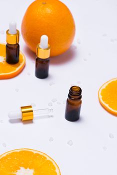 Branding mock-up. Natural essential oil, Cosmetic bottle containers with orange slices.