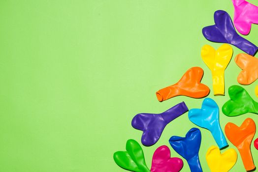 Celebration Flat lay with colorful balloons on green background.