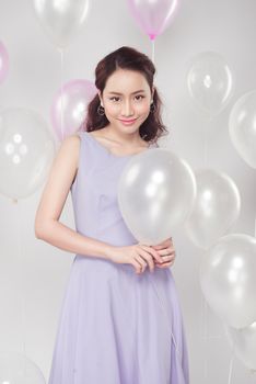 Stylish beautiful asian woman with pastel balloons