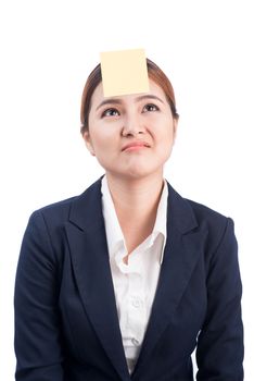 A portrait of a young confused business woman with a sticky note on her forehead