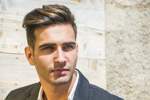 Headshot of handsome young man outdoor in the sun