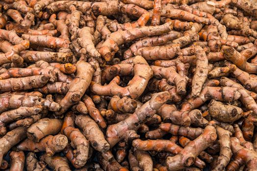 Full basket of turmeric is on display for sale in the fresh vegetable market