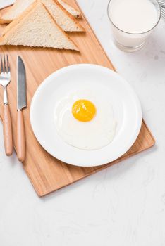 Top view of traditional healthy easy quick breakfast meal made of fried eggs served on a plate.