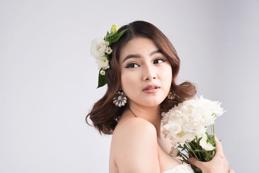 Beautiful asian woman bride on grey background. Closeup portraits with a professional makeup