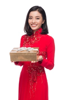 Charming Vietnamese Woman in Red Ao Dai Traditional Dress holding Gift box.