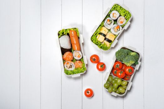 Bento box with different food, fresh veggies and fruits
