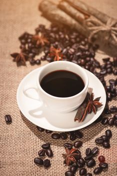 Coffee cup and coffee beans on table