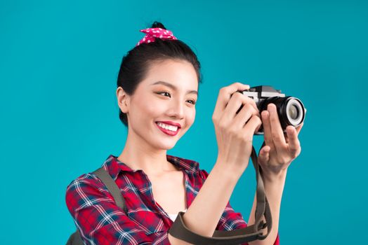 Woman travel. Young beautiful asian woman traveler taking pictures on blue background