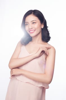 Beautiful happy cute asian woman in casual pink dress with red lips on white background