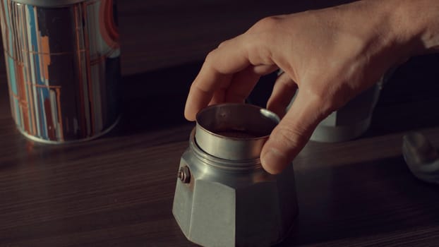 Close up of man's hand opening coffee geyser