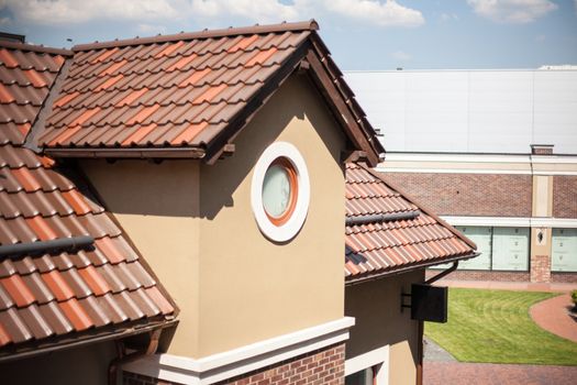 Detail of overlapping roofing tiles on a new build with window