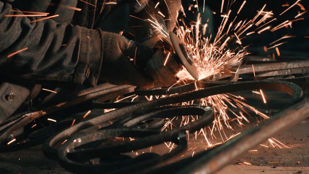 Close up of man's hands smoothing metal grate