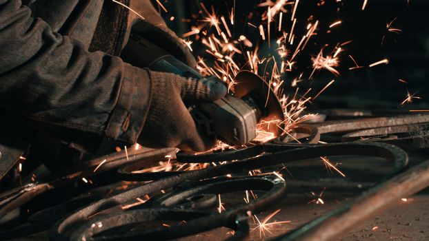 Close up of man's hands smoothing metal grate