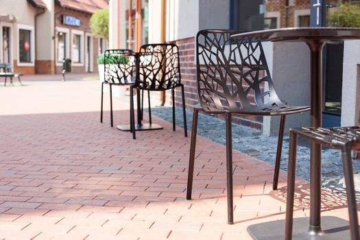 Modern carved chairs with trees in a cafe on the street