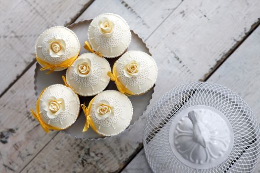 Beautiful wedding cupcakes with orange ribbon