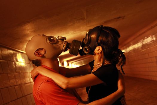 Married couple in gas masks in a tunnel