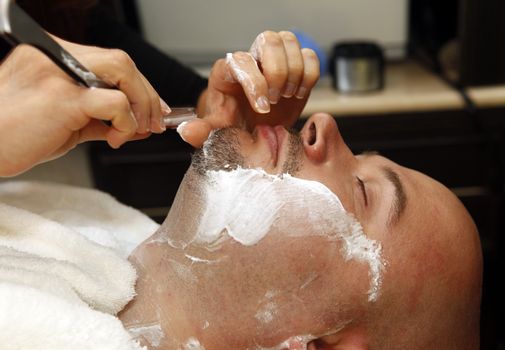 The man is shaved by a beard