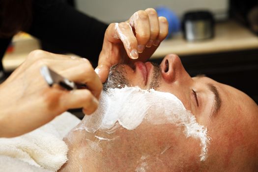 The man is shaved by a beard