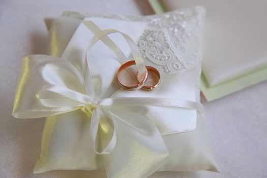 Wedding rings on a satiny fabric