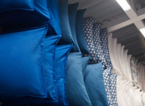 many colorful pillows on shelves in the closet
