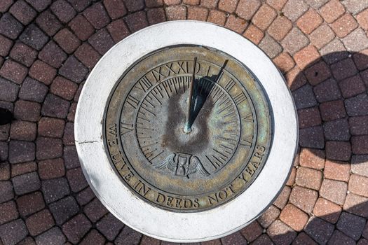 A sundial shows the time in the early afternoon.