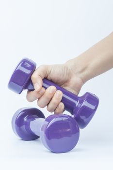 Woman hand holding dumbbell weight isolated on white background, stock photo