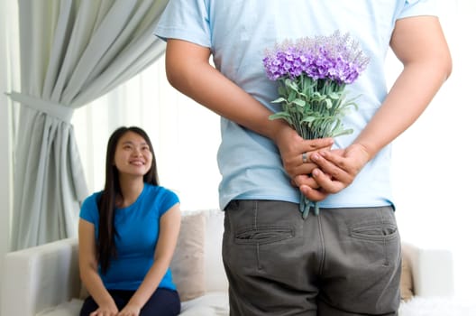 young Man offering  flowers to his girlfriend