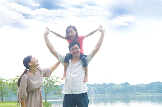 Happy Asian Family enjoying family time together in the park