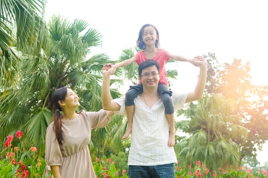 Happy Asian Family enjoying family time together in the park