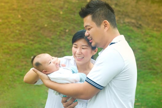 outdoor portrait of happy asian family