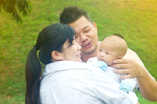 outdoor portrait of happy asian family