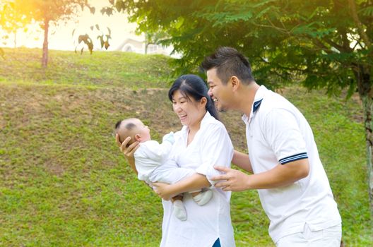 happy asian young family spending time outdoor on a summer day