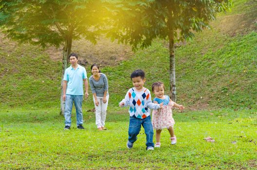 Outdoor portrait of happy asian family